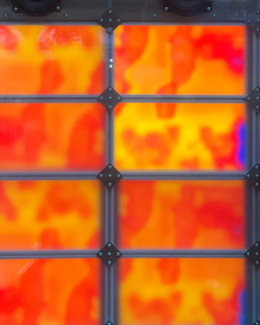 Panels glowing orange and yellow, divided by a dark metal grid