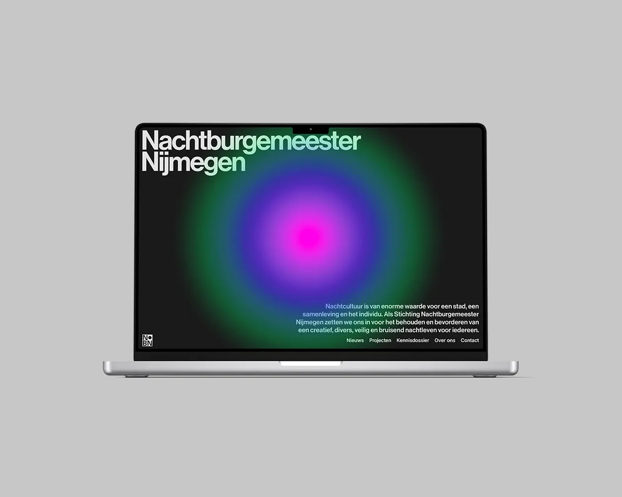 The website on a laptop, a magenta and green gradient on black