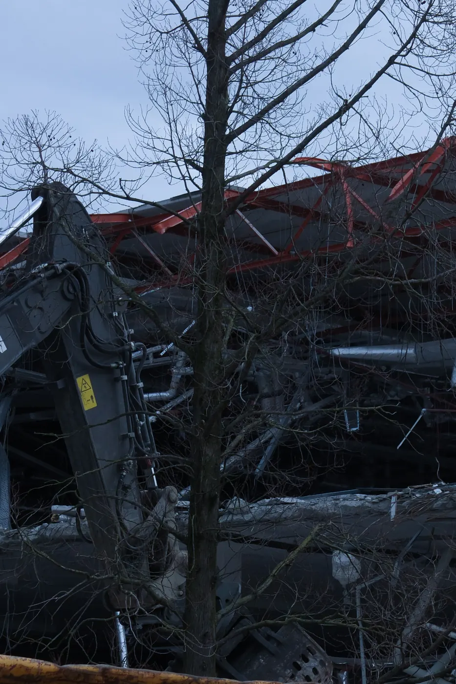 Demolition in the city, seen through bare branches