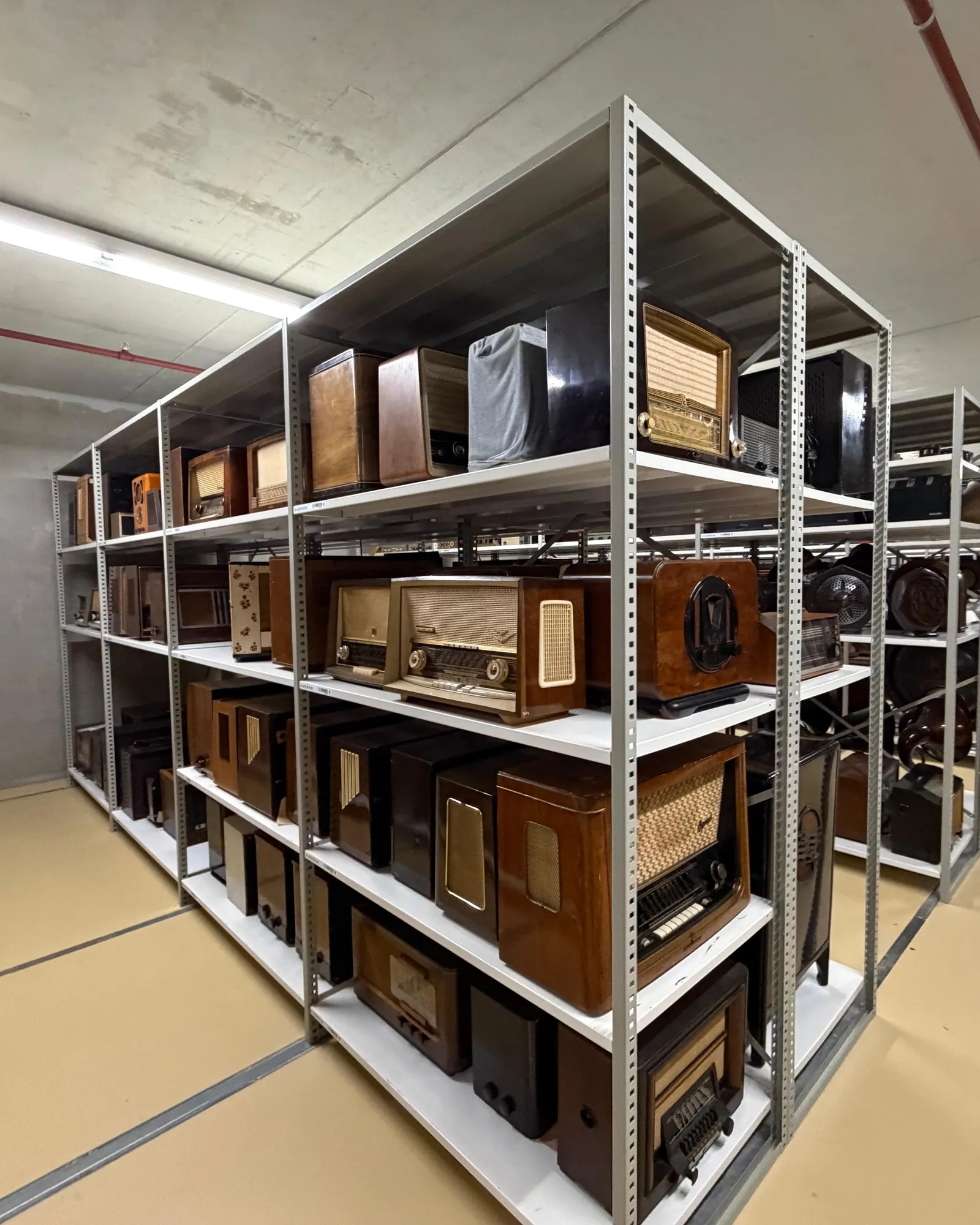 Visit to Sound & Vision: shelves of historic radio sets in the depot.