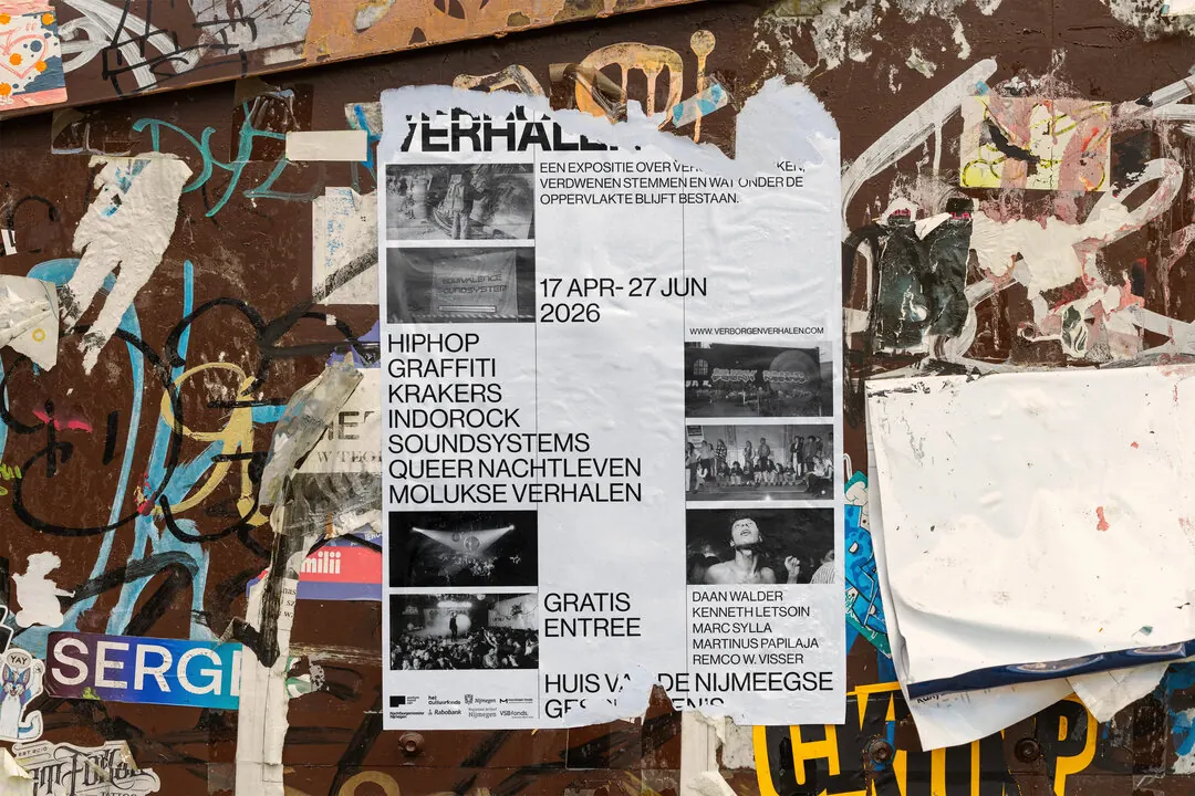 Exhibition poster on a wall of torn posters